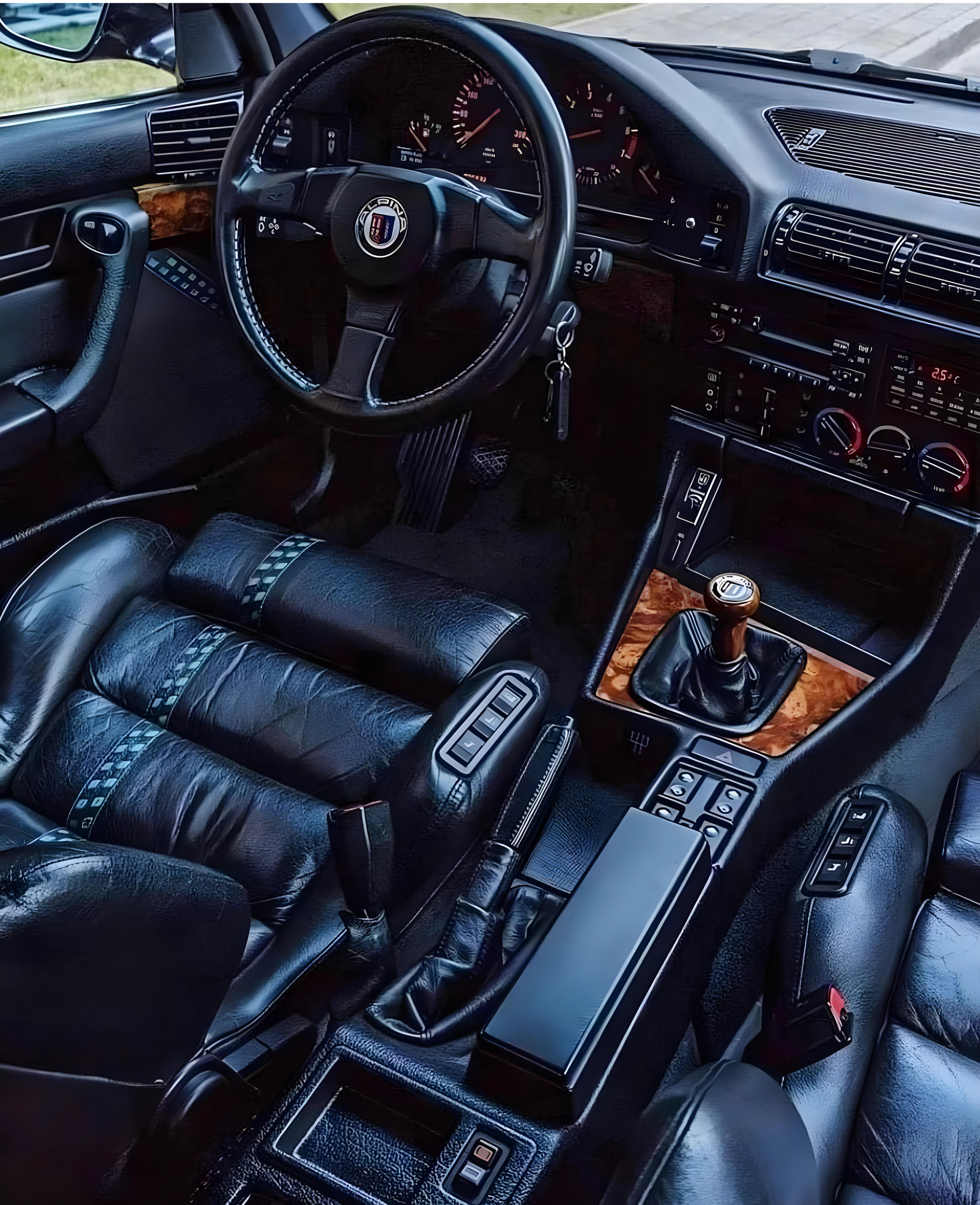 BMW E34 Alpina B10 interior, showcasing its luxurious and refined design with high-quality materials, comfortable seating, and advanced features. The image highlights the car's elegant and sophisticated cabin layout.
