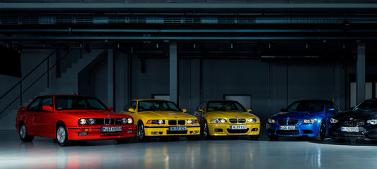 A lineup of iconic BMW M3 models showcasing the evolution of the M Division: the classic E30 M3, the refined E46 M3, the sleek E36 M3, and the powerful E90 M3. Each car represents a different era of BMW's legendary Motorsport engineering.