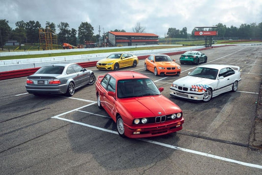 Image showcasing a lineup of BMW cars featuring various E codenames, including models like the E30, E36, and E39, highlighting the evolution and iconic design of these classic vehicles.