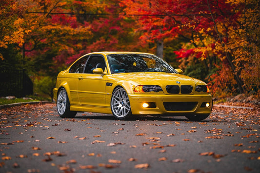 Yellow BMW E46 M3 showcasing its sleek design and iconic performance heritage. Park in the nature in Autumn. Bavarian old school