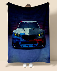 Person holding a blanket with a BMW car design on a beige background