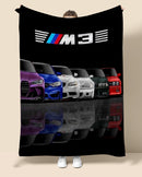 Blanket with BMW M3 logo and colorful cars on a black background