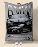Person holding a BMW branded blanket with car design