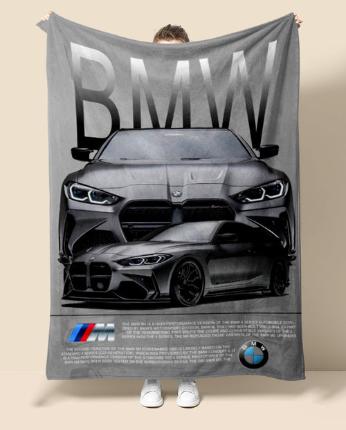 Person holding a BMW branded blanket with car design