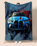 Person holding a blue BMW M4 G82 car-themed blanket. Bue Racer from Bavarian old school