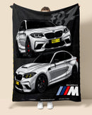 Person holding a blanket with BMW  M2 car design