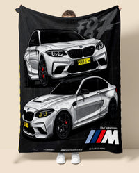 Person holding a blanket with BMW  M2 car design