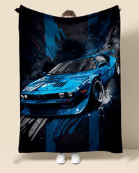 Blue car BMW m1 design on a blanket held by a person against a beige background