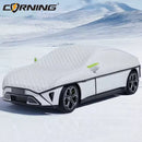 Car covered with a white car cover in a snowy landscape, bavarianold school.