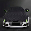 Car covered with a black car cover on a dark background, bavarian old school