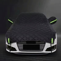 Car covered with a black car cover on a dark background, bavarian old school