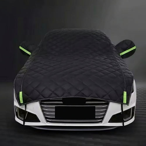 Car covered with a black car cover on a dark background, bavarian old school