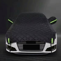 Car covered with a black car cover on a dark background, bavarian old school