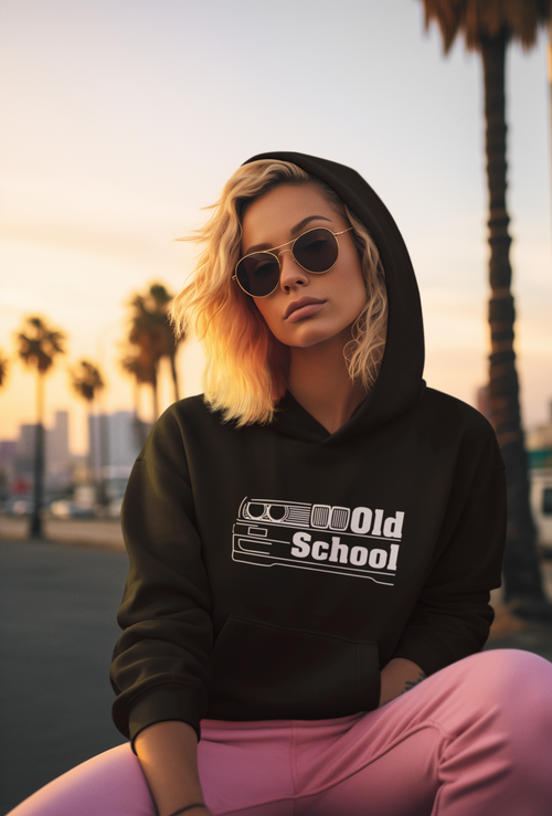 Person wearing a black hoodie with 'Old School' text, sitting outdoors with palm trees in the background.