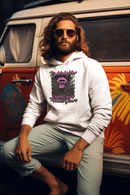 Man wearing a white hoodie with graphic design sitting in front of a colorful van.