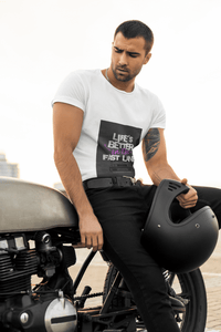 Man sitting on a motorcycle holding a helmet, wearing a white t-shirt with text Life`s better in the fast lane. bavarian old school